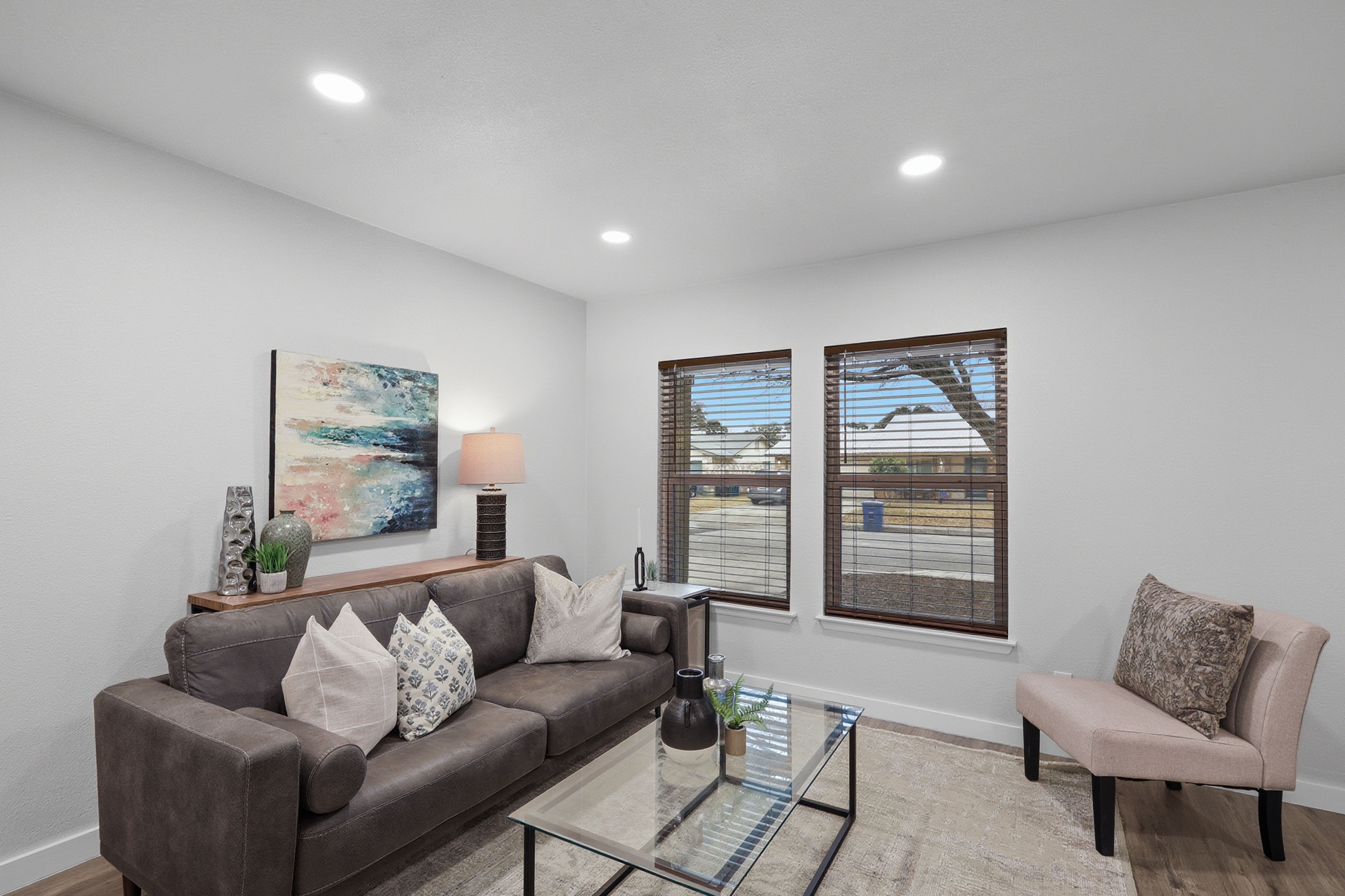 Formal living room seating area with natural window light